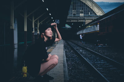 Full length of young man at railroad station at night