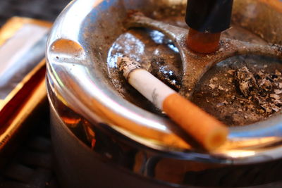 Close-up of burnt cigarette in ashtray