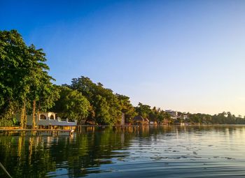 Scenic view of lake against clear blue sky