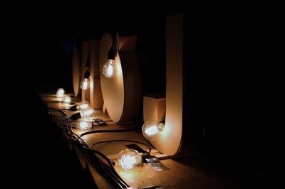 Close-up of illuminated lamp on table