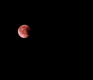 Low angle view of moon against sky at night