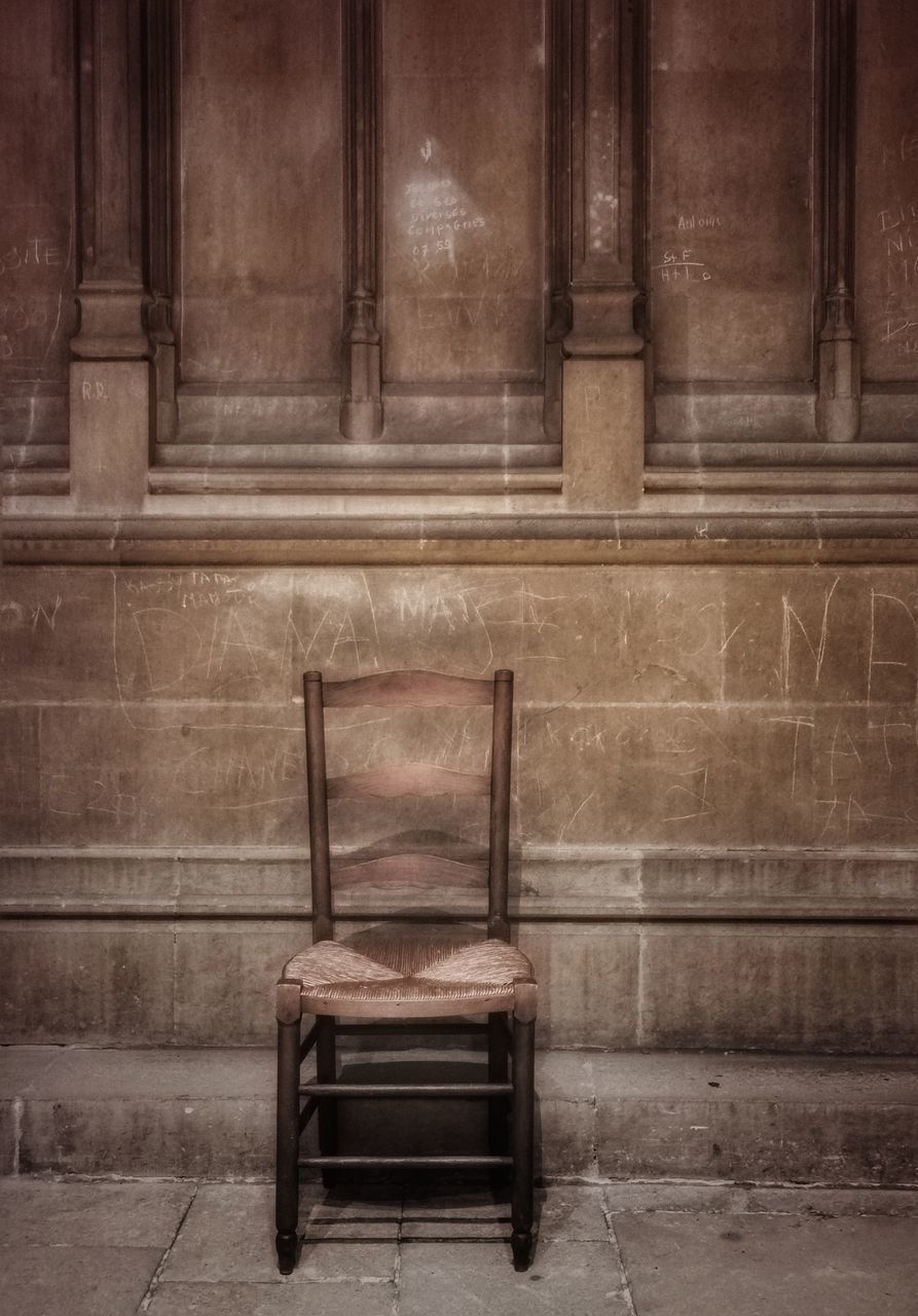 EMPTY BENCH AGAINST WALL