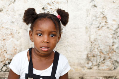 Portrait of girl against wall