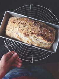 High angle view of hand holding bread