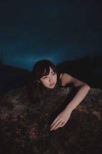 Portrait of a beautiful young woman at night