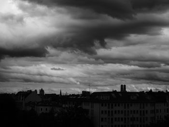 Buildings against cloudy sky