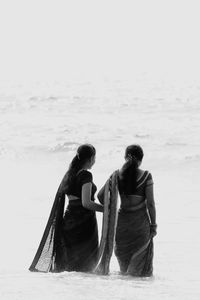 Rear view of women at beach