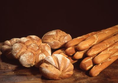 Variety of brown loaf breads on wooden table