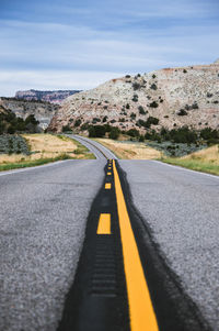 Road amidst mountains against sky