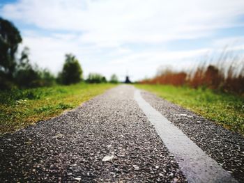 Surface level of road on landscape against sky