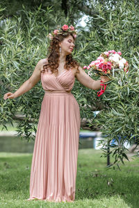 Rear view of woman standing on grassy field