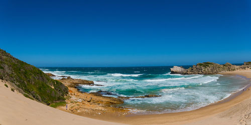 Scenic view of sea against clear blue sky