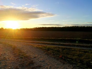 Scenic view of field against sky during sunset