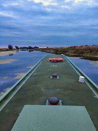 Aerial view of swimming pool by lake against sky