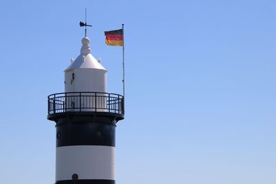 Low angle view of lighthouse against clear blue sky