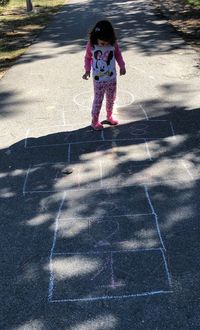 Full length of woman standing on road