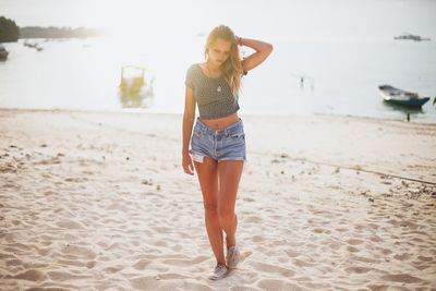 Full length of woman standing on beach