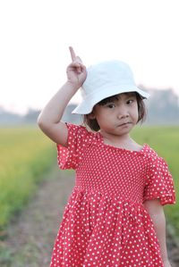 Cute baby girl standing on field