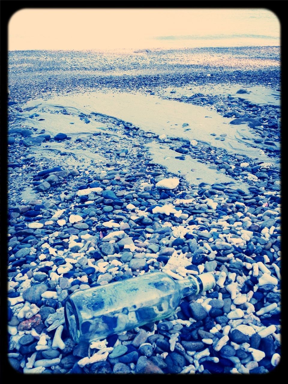 transfer print, water, auto post production filter, sea, nature, tranquility, beauty in nature, beach, scenics, tranquil scene, high angle view, shore, outdoors, day, no people, horizon over water, blue, sunlight, reflection, idyllic