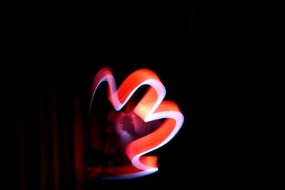 Close-up of illuminated lamp in darkroom