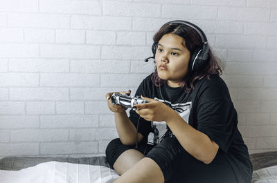 Asian girl with purple hair, generation z, holding joystick, playing video game, weekend at home