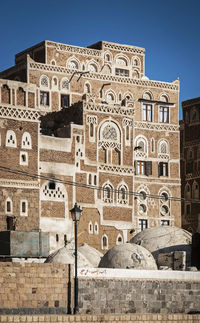 Low angle view of historical building against clear blue sky