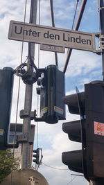Low angle view of road sign against sky