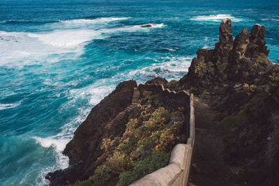 High angle view of rocks at sea shore