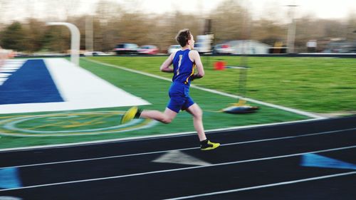 Full length of man running on track