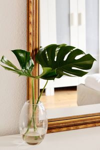 Close-up of glass vase on table at home