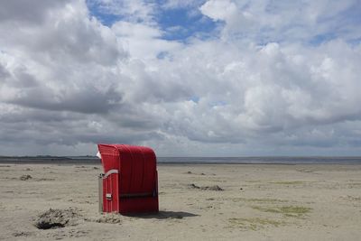 Lifeguard hut on beach against sky