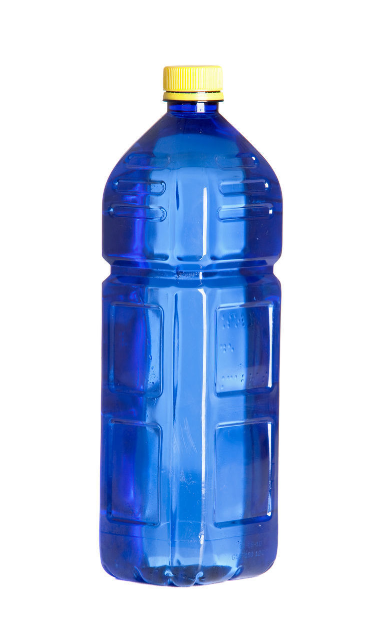 CLOSE-UP OF BLUE GLASS BOTTLE AGAINST WHITE BACKGROUND