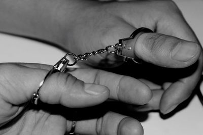 Cropped image of hands with handcuff