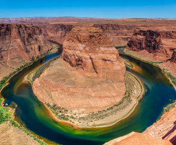 The colorado river flows through the horseshoe bend, near page arizona