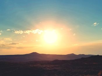 Scenic view of mountains against sky during sunset