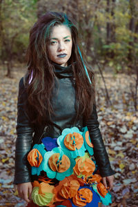 Portrait of woman standing in forest