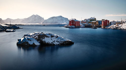 Scenic view of bay in city against clear sky