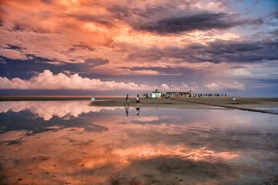 Reflection of cloudy sky in lake during sunset