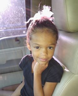 Portrait of cute girl sitting on seat