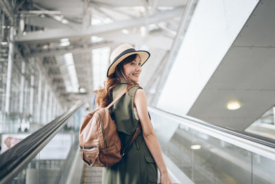 Woman standing at airport terminal