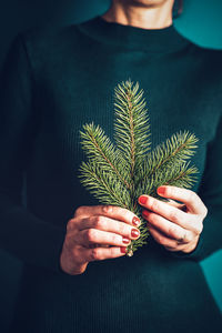 Midsection of woman holding plant