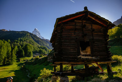 House amidst trees and buildings against sky