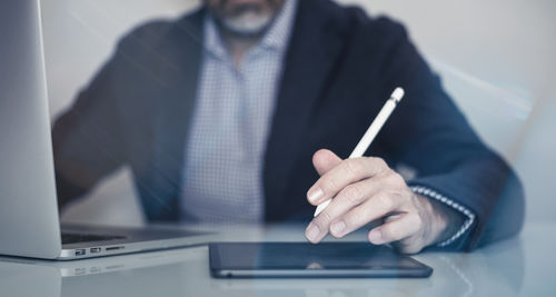 Midsection of businessman working in office