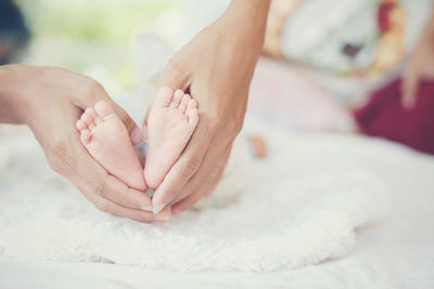 Close-up of mother holding feet