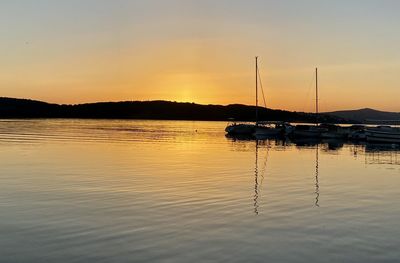 Sailboats in marina at sunset