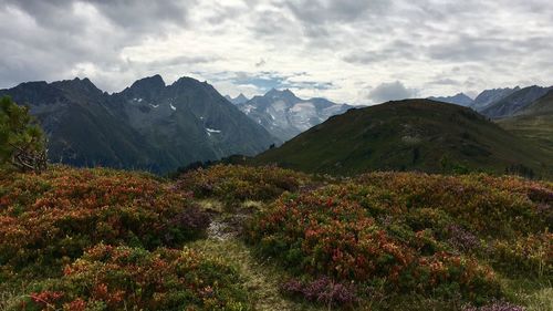 Scenic view of mountains against cloudy sky