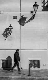 Full length of man on street against building