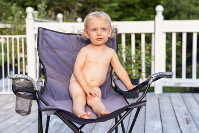 Portrait of boy sitting on chair