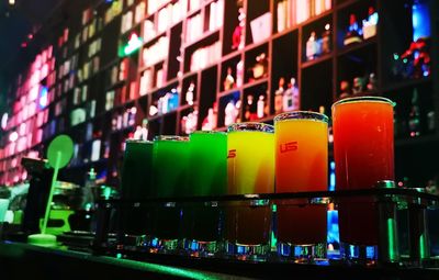 Close-up of multi colored bottles on table