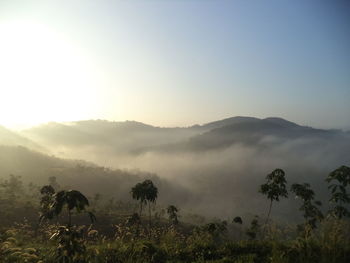 Scenic view of mountains against sky during foggy weather